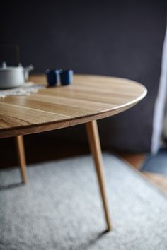 a wooden table sitting on top of a carpeted floor