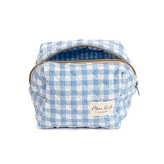 Our Azure Mini Bag is a stylish and compact carry-all designed to hold your essentials with a classic look. The quilted exterior is made from a beautiful blue gingham material, complemented by a matching gingham interior. Ideal for organizing your makeup and beauty essentials or serving as a travel organizer (especially when you need something more compact than our large bags), this is a must-have for anyone who values both organization and style. Size: 6" x 4" x 5" Mini Essentials, Cute Blue Cosmetic Bag For School, Gingham Bags With Zipper Pouch For Daily Use, Daily Use Gingham Bags With Zipper Pouch, Versatile Blue Pouch Cosmetic Bag, Cute Blue Cosmetic Bag, Gingham Pouch Bag For Daily Use, Blue Quilted Bag For On-the-go, Blue On-the-go Pouch Cosmetic Bag