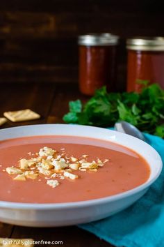 a white bowl filled with soup next to crackers