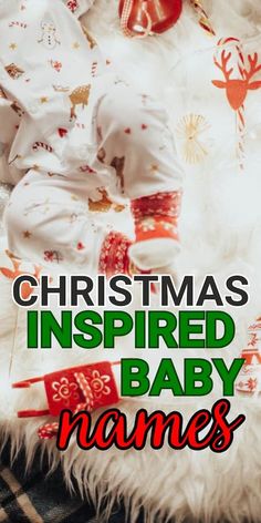 a baby laying on top of a white blanket next to christmas decorations and presents with the words, christmas inspired baby names