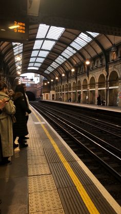 people are waiting for the train to arrive at the station in this photo, there is no image here