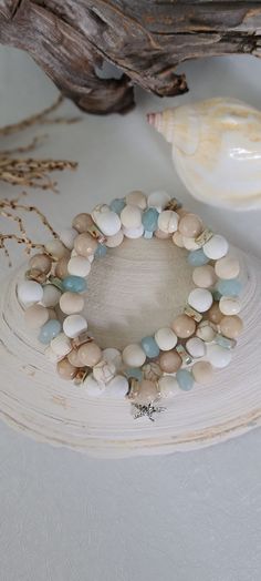 TitiTataStore.com Always FREE SHIPPING and a FREE GIFT! I Will Ship Within 24 Hours! Description:  A Set of 3 Beachy Style Handmade Bracelets.  Beautiful Summer Beach Vacation Vibes! Materials: 8mm Beige Faceted Jade Beads, 8mm Rondelle Blue Quartz Beads, 8mm Matte White Magnesite Beads, 8mm Ivory Matte Jasper Beads, 8mm Natural White Matte Turquiose Beads, 8mm Wood Beads and, 8mm Sea Sediment Jasper Heishi Beads.  A lovely starfish charm complement this beachy set.  Every bracelet is handmade using a high-quality elastic stretch cord for durability. Size: Each bracelet is suitable for a small wrist circumference of about 7".    Final Touch: Your bracelet will be nicely packed in a Burlap Gift Bag. ❤ All orders are shipped FREE via USPS First Class Mail with tracking number. ❤ If you would Bracelets Beachy, Coastal Bracelet, Beach Style Jewelry, Inspired Bracelets, Girls Trip Gifts, Burlap Gift Bags, Coastal Jewelry, Beachy Style, Coastal Theme