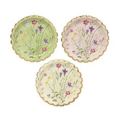 three plates with flowers painted on them, one is green and the other is pink