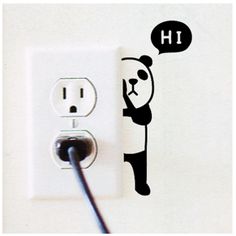 an electrical outlet with a sticker of a panda holding a speech bubble