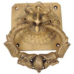 an ornate brass door handle with a dragon face