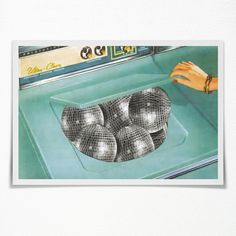 a woman's hand is reaching for some balls in the sink