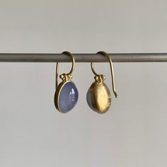 Soothing Namibian chalcedony glow from within their yellow gold frames in this splendid pair. 18k yellow gold Chalcedony, 7.75ctw, 8mm x 11mm (5/16" x 7/16") Earrings hang 13/16" from the ear Each earring weighs 2.1g Formal Yellow Gold Chalcedony Jewelry, Handmade Gold Earrings With Chalcedony, Gold Oval Cabochon Earrings With Polished Finish, Luxury Gold Oval Cabochon Earrings, Yellow Gold Chalcedony Jewelry With Cabochon, Chalcedony Cabochon Yellow Gold Jewelry, Modern Gold Cabochon Earrings, Cabochon Earrings, Gold Frames