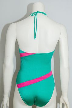 A beautiful vintage swimsuit from the 80's, by Triumph International, in bright green and pink colours. The swimsuit is used and in a very good condition. Brand size Size :EU:42, I-3 Bust : 31 cm Waist : 31 cm Length : 53 cm Material : Poliamid, Elastane Thank you for visiting our shop! Vintage Green Summer Swimwear, Framed Vintage Swimwear, 80s Swimsuit Bikinis, 80s Swimsuit Vintage, 80s Swimsuit, Vintage Swimsuit, Bright Green, Women Swimsuits, Tankini