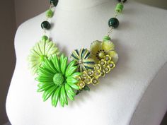 This entire necklace was designed around the spray of tiny yellow enamel flowers that have rhinestone centers and green leaves.  Previously a vintage brooch, I combined it with four other vintage enamel flower brooches in complementary shades of lemon yellow, lime green, and grass green (all backs removed).  This beautiful bouquet is securely mounted upon a clear lucite necklace base and measures approximately 6 inches across by 4 inches top to bottom (at its widest and tallest points).   I've a Green Flower Pendant Jewelry For Wedding, Green Enamel Jewelry For Wedding, Green Enamel Wedding Jewelry, Green Flower Pendant Necklace For Wedding, Green Flower-shaped Enamel Jewelry, Green Gardens, Blue Words, Yellow Lime, Yellow Jade