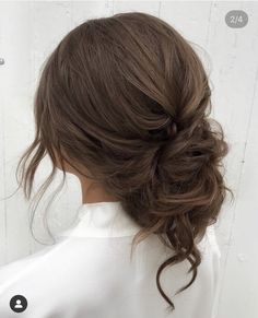 a woman with her hair in a low bun