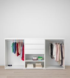 a white cabinet with clothes hanging on it