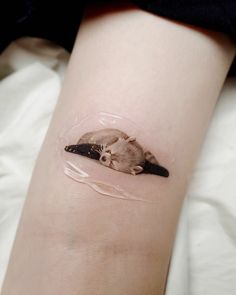 a small sticker on the arm of a person with a mouse in it's stomach