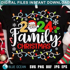 family christmas shirt with santa clause on it, surrounded by holiday decorations and stockingss