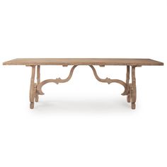 a wooden table with an ornate design on the top and legs, against a white background