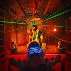 a man in a room with laser glasses on his face