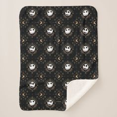 a black and white blanket with cartoon faces on it