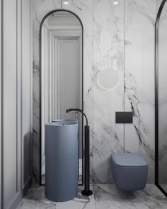 a bathroom with marble walls and flooring is pictured in this image, there are two round mirrors on the wall