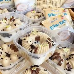 several plastic containers filled with desserts on top of a table