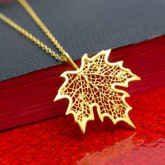 Gold Maple Leaf Necklace, 24k Gold Vermeil Style Leaf Pendant & Gold Filled Chain, Botanical Tree Leaf Jewelry, Filigree Leaf, Autumn Gift, FREE SHIPPING Add a touch of nature to your look with this elegant and detailed 24 karat gold Vermeil style maple leaf pendant necklace. The gold maple leaf can be matched with your choice of 14 karat gold filled chain. What is Vermeil Style? Gold vermeil jewelry refers to gold plated over 925 sterling silver. To be considered Vermeil the gold layer must be Maple Leaf Necklace, Autumn Necklace, Gold Vermeil Jewelry, Autumn Gifts, Leaf Jewelry, Vermeil Jewelry, Pendant Gold, Leaf Necklace, Leaf Pendant