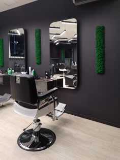 a hair salon with chairs and mirrors on the wall