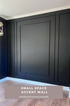 an empty room with black walls and wood flooring in the background, there is a small space accent wall