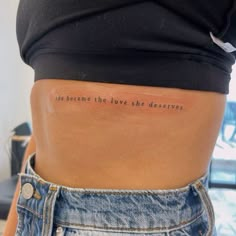 the back of a woman's stomach with an inscription on it that says, we become the love she deserves