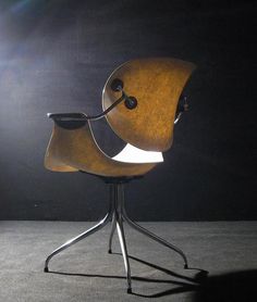 a chair that is sitting in the middle of a room with light coming from behind it