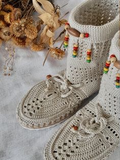 Off-White Beaded Crochet Boot For Women A pair of ethnic boot will give you an authentic look that you want! Because of it is knitted by a crochet, won't make your feet sweat.  So, it may be perfect fit even with your summer combine. Hi, welcome to my shop! All items are made in my home. I knit them all with a crochet. Thank you for your visit and please feel free to contact me for any questions!  All my best from Bodrum/Muğla :) Eclectic Crochet, Home In Winter, Boot For Women, Color Socks, Womens Booties, Crochet Boots, Knitted Booties, Beaded Crochet, Crochet Clutch