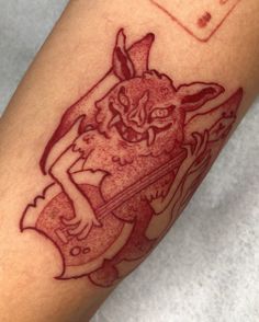 a close up of a person's arm with a tattoo design on the arm