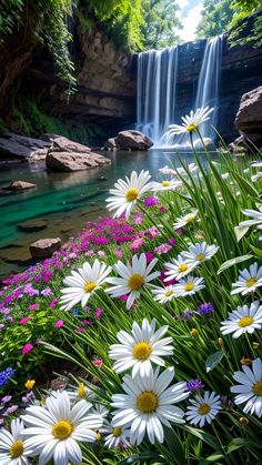 flowers are in the foreground and a waterfall is in the background with water running through it