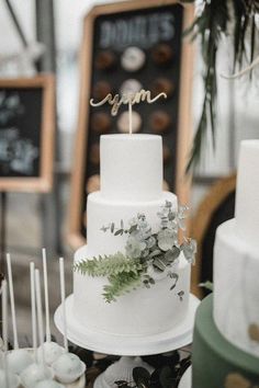 a white wedding cake sitting on top of a table