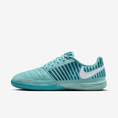 the nike zoom tennis shoe is light blue and has white stripes on the upper part