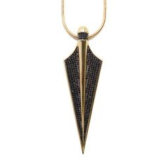 a gold necklace with black diamonds on the front and back side, hanging from a chain