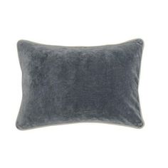 the grey velvet pillow is shown on a white background