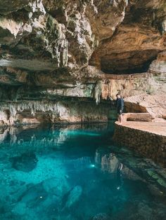 a man standing on the edge of a cave