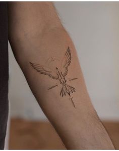 a small bird tattoo on the arm