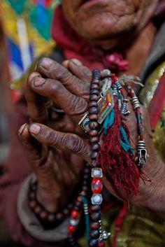 an old woman with bracelets on her hands