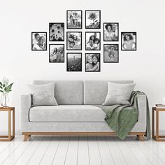 a living room with a couch, table and pictures on the wall above it in black and white