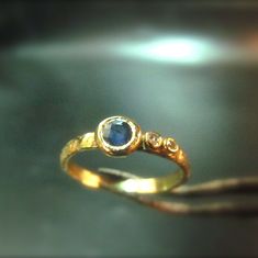 a gold ring with a blue stone on it