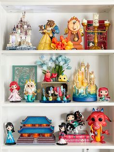 the shelves are filled with figurines and other decorative items, including princesses