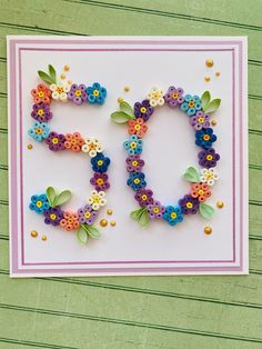 a handmade greeting card with flowers and the number 50