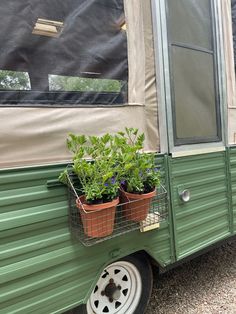 a green trailer with some plants in it