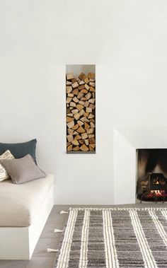 a living room filled with furniture and a fire place next to a wall mounted fireplace