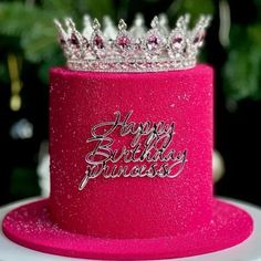 a pink birthday cake with a tiara on top and happy birthday princess written on it