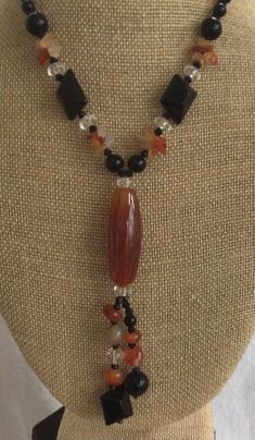 "Featuring this beautiful carnelian, black onyx and clear Quartz semi-precious beaded \"Y\" necklace. The necklace measures 16\" and is in excellent vintage condition. It has a silver tone lobster claw clasp." Onyx Beaded Necklaces For Jewelry Making, Healing Onyx Beaded Necklaces With Black Beads, Onyx Necklaces With Natural Stones For Healing, Healing Onyx Beaded Necklace With Black Beads, Onyx Necklace With Natural Stones For Healing, Onyx Beaded Necklaces For Healing, Elegant Onyx Beaded Necklace For Healing, Healing Onyx Necklace With Natural Stones, Onyx Necklace With Black Beads For Healing