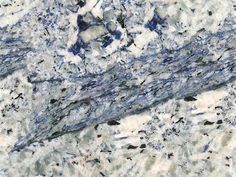 blue and white marble with black dots on it's edges is shown in this image