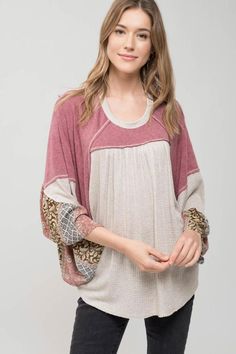 This casual blouse features a flowy knit style with a contrasting pattern detail on the sleeves. Knit Tops With Striped Sleeves For Fall, Fall Knit Top With Striped Sleeves, Oversized Patchwork Tops For Layering, Oversized Jacquard Knit Crew Neck Top, Bohemian Crew Neck Top For Layering, Knit Tops With Striped Long Sleeves, Fall Textured Knit Top With Balloon Sleeves, Casual Blouse With Striped Sleeves For Spring, Bohemian Long Sleeve Loungewear Blouse