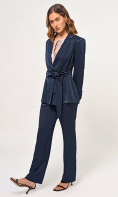 Bring your wardrobe to life with the Katherine Waist Tie Blazer. Crafted from navy blue satin, this piece of tailoring features a svelte waist tie for the perfect fit and complements perfectly with coordinating straight leg trousers. Captivating and refined, this blazer will elevate any ensemble. Blazer Waist tie Notched lapel Lined Length: 27 3/4" Chest: 17 1/2" Self: 100% Polyester Lining: 100% Polyester Hand wash in cold water with similar colors. Model is wearing a size small Style #: G237J1 Tie Waist Blazer, Ensemble Blazer, Tie Blazer, Dark Blue Tie, Waist Blazer, Church Fits, Comfortable Pants, Luxury Women Fashion, Straight Trousers