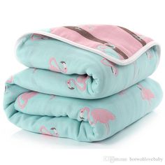 three blankets stacked on top of each other with pink flamingos and brown trims