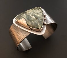 Handmade sterling silver cuff bracelet with a large septarian gemstone. Unique Sterling Silver Cuff Jewelry, Unique Polished Cuff Jewelry, Modernist Cuff Jewelry For Gift, Unique Hand Forged Cuff Bracelet For Formal Occasions, Unique Hand Forged Cuff Bracelet For Formal Events, Unique Polished Cuff Bracelet As Gift, Unique Polished Cuff Bracelet Gift, Modernist Cuff Jewelry With Polished Finish, Unique Polished Finish Cuff Bracelet Gift